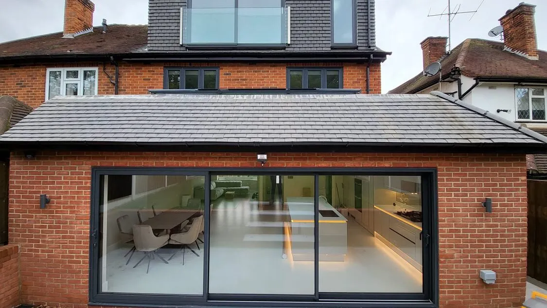 A brick building with a glass sliding door.